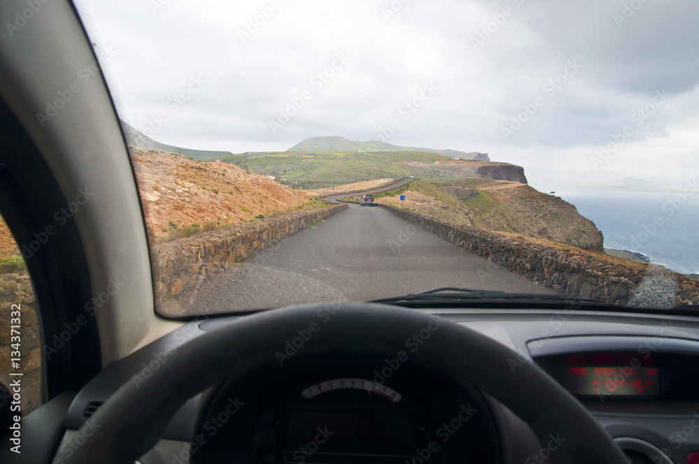 Driving on a scenic coastal road - point of view