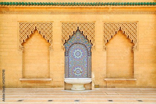 Moroccan style fountain with colorful mosaic tiles photo