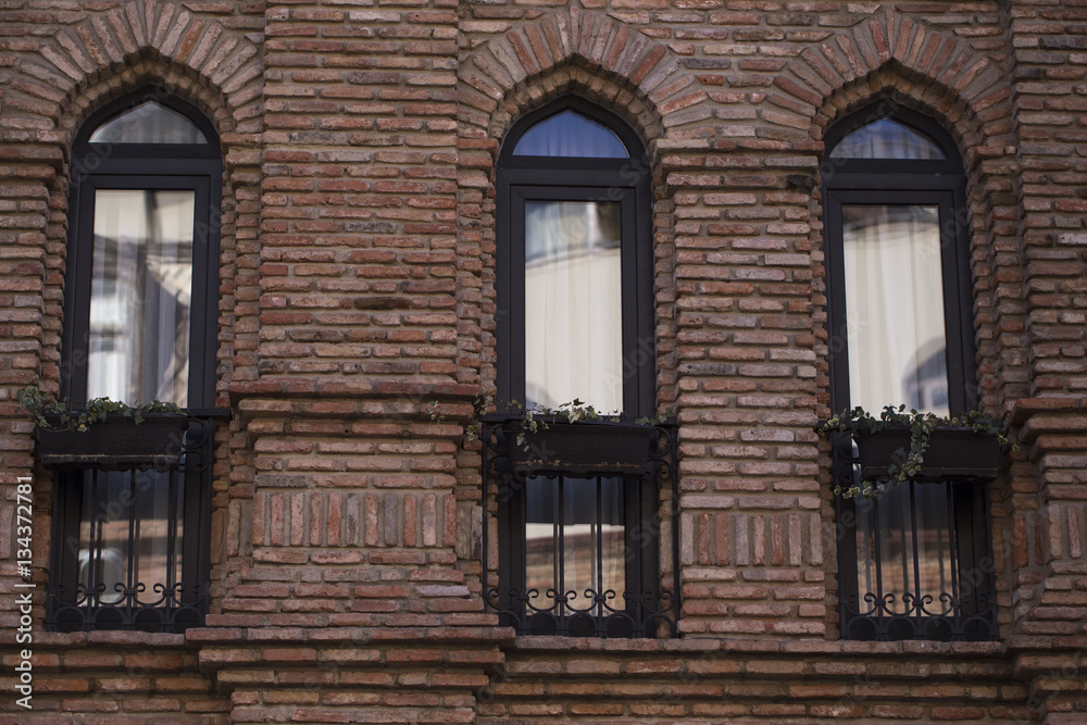 Facade with three narrow windows of the building.