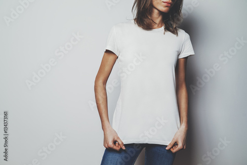 Young Hipster Girl Wearing Blue Jeans And Blank White T Shirt With Area For Your Logo Or Design Mock Up Of White T Shirt White Wall In The Background Stock Photo Adobe Stock Young Hipster Girl Wearing Blue Jeans And Blank White T Shirt With Area For Your Logo Or Design Mock Up Of White T Shirt White Wall In The Background Stock Photo Adobe Stock