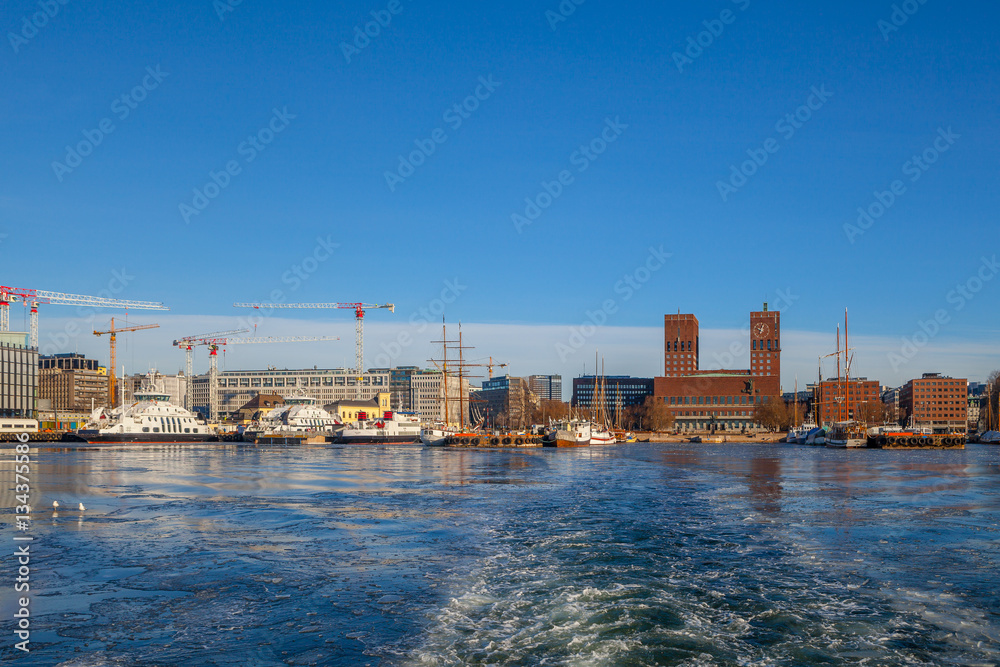OSLO, NORWAY, 28 FEB 2016: View of City hall, boats and harbour from water