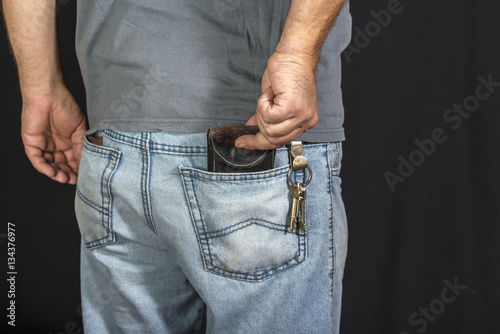 man's hand taking wallet