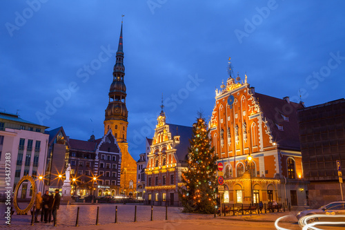 Illuminated City Hall Square with House of the Blackheads and Saint Peter church in Old Town
