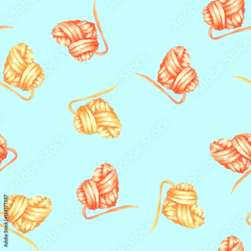 Seamless pattern with watercolor yellow and red heart ball of yarn; hand drawn on a blue background