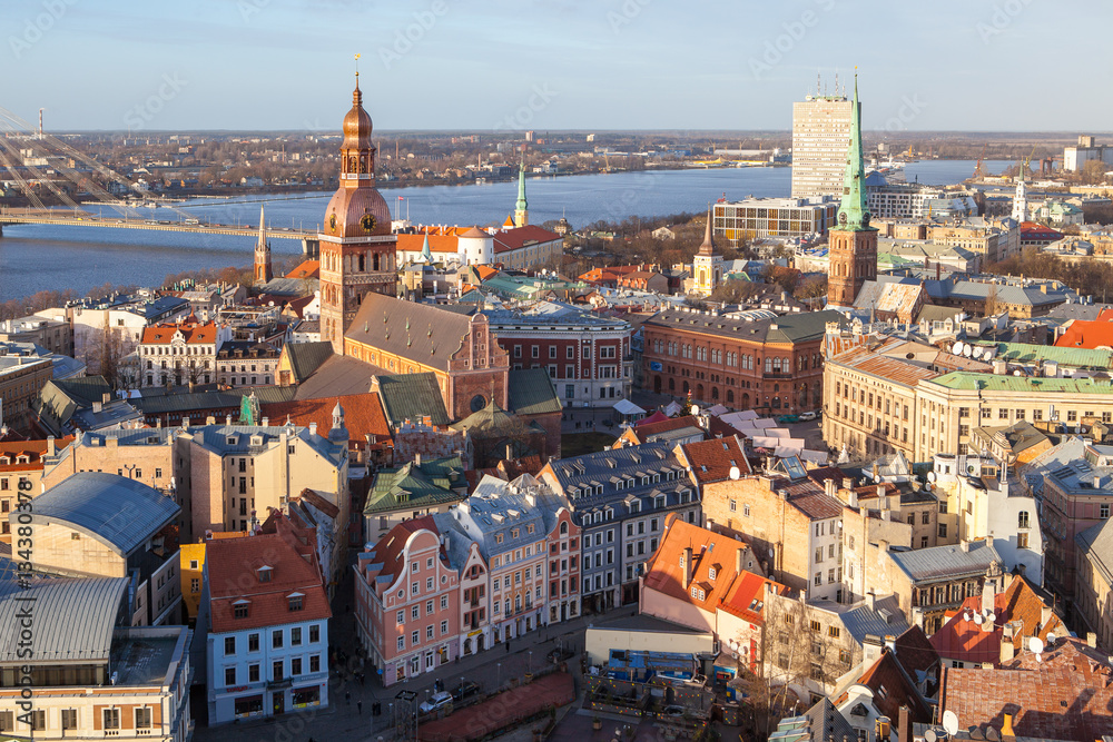 Fototapeta premium Aerial panoramic view of old town, Daugava river and modern bridge over river. Clear sunny day.