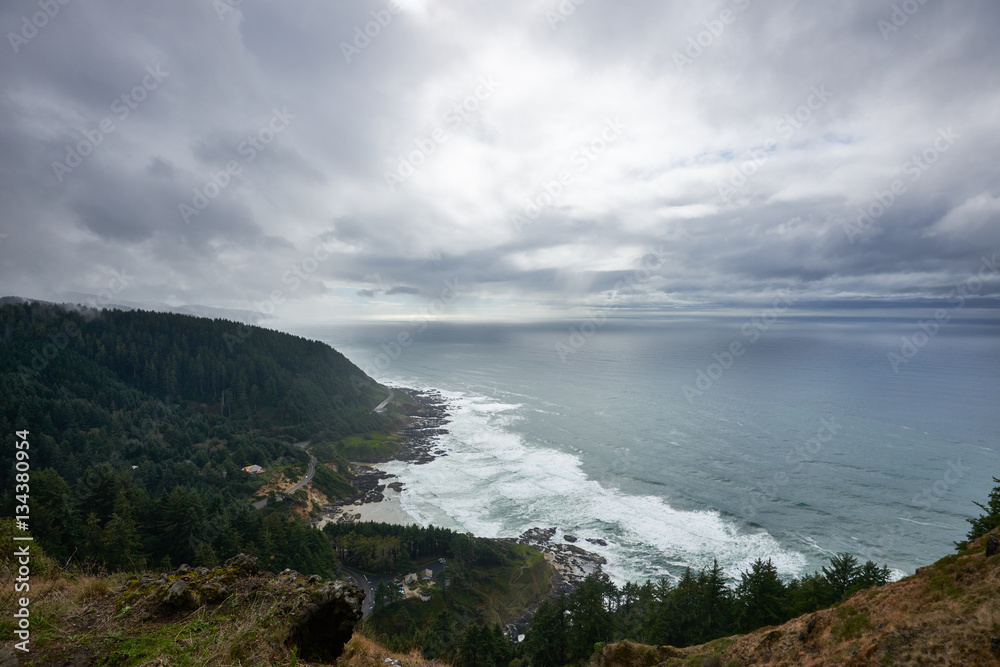 Ocean and coastline view from Cape Perpetua overlook in cloudy rainy day. Oregon, USA.