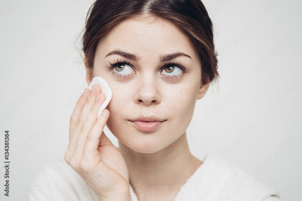 woman with a sponge blue background cotton pad problem skin woman with a sponge blue background cotton pad problem skin