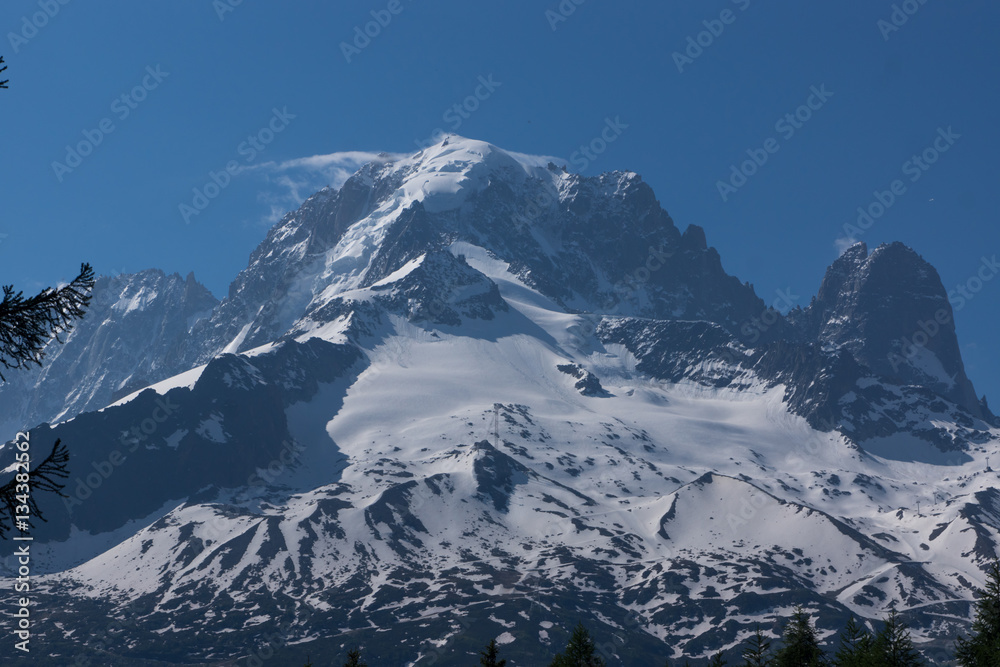 Mountain peaks with snow and light clouds. Summer in French Alps, MontBlanc