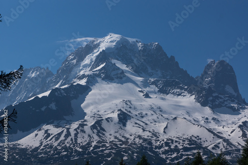 Mountain peaks with snow and light clouds. Summer in French Alps, MontBlanc