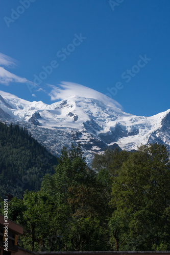 Mountain peaks with snow, light clouds and green trees. Summer in French Alps, MontBlanc © yashka7