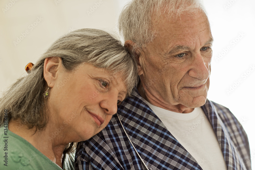Senior woman comforting her unwell husband. Senior woman comforting her unwell husband.