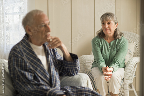 Senior woman comforting her unwell husband.