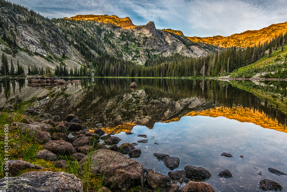 Fototapeta premium Sunrise reflection on high mountain lake in Montana's Bitterroot Mountains