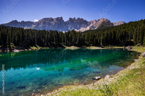View of Karersee (Lago di Carezza), one of the most beautiful alpine lakes in the Italian Dolomites.