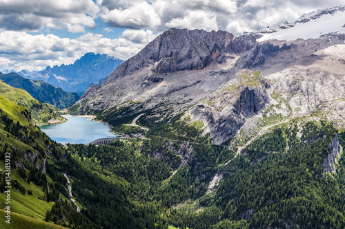 View of the Marmolada, also known as the Queen of the Dolomites and the Fedaia Lake. Marmolada is the highest mountain of the Dolomites, situated in northeast of Italy.