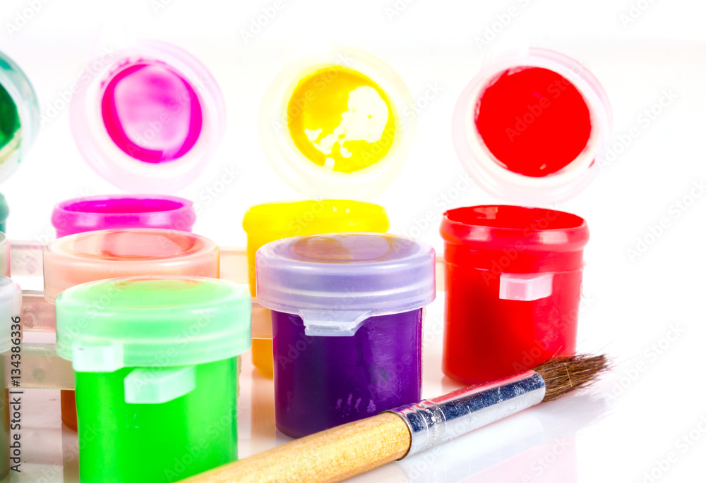 set of paints with a brush on a white background with a short focus