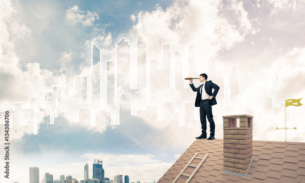 Engineer man standing on roof and looking in spyglass. Mixed med Engineer man standing on roof and looking in spyglass. Mixed med