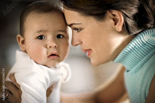 Close-up of mother holding her baby boy