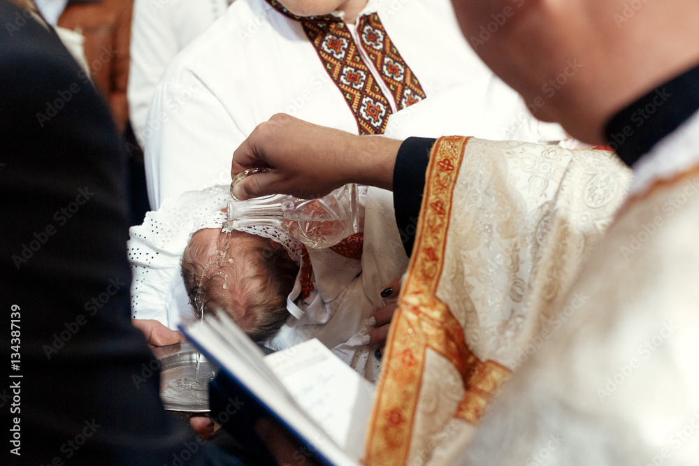 baptism baby with holy water pouring on head  at christening cer - obrazy, fototapety, plakaty 
