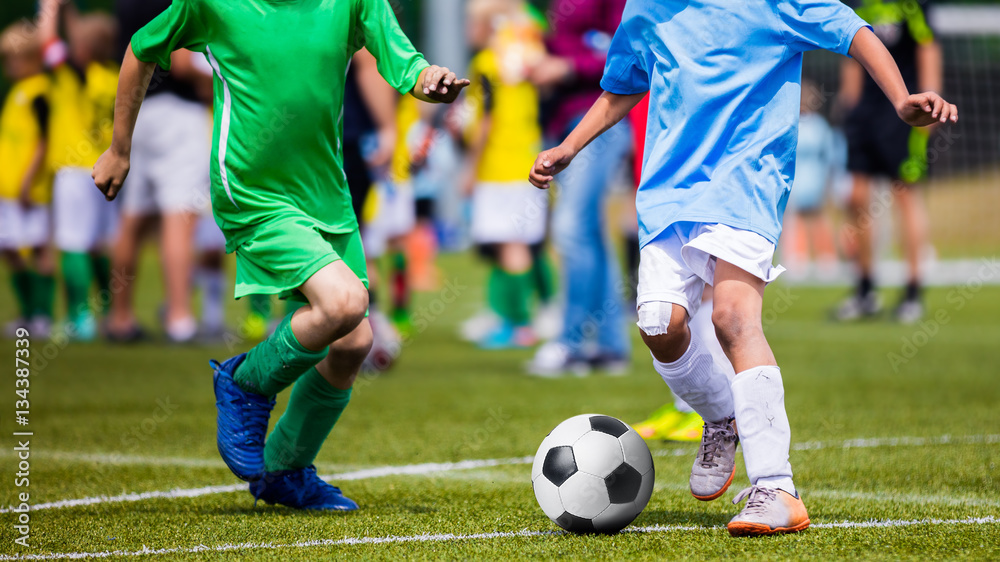 Running Young Soccer Football Players. Footballers Kicking Football Match Game. Youth Soccer Players Running After the Ball. Soccer Team in the Background Running Young Soccer Football Players. Footballers Kicking Football Match Game. Youth Soccer Players Running After the Ball. Soccer Team in the Background