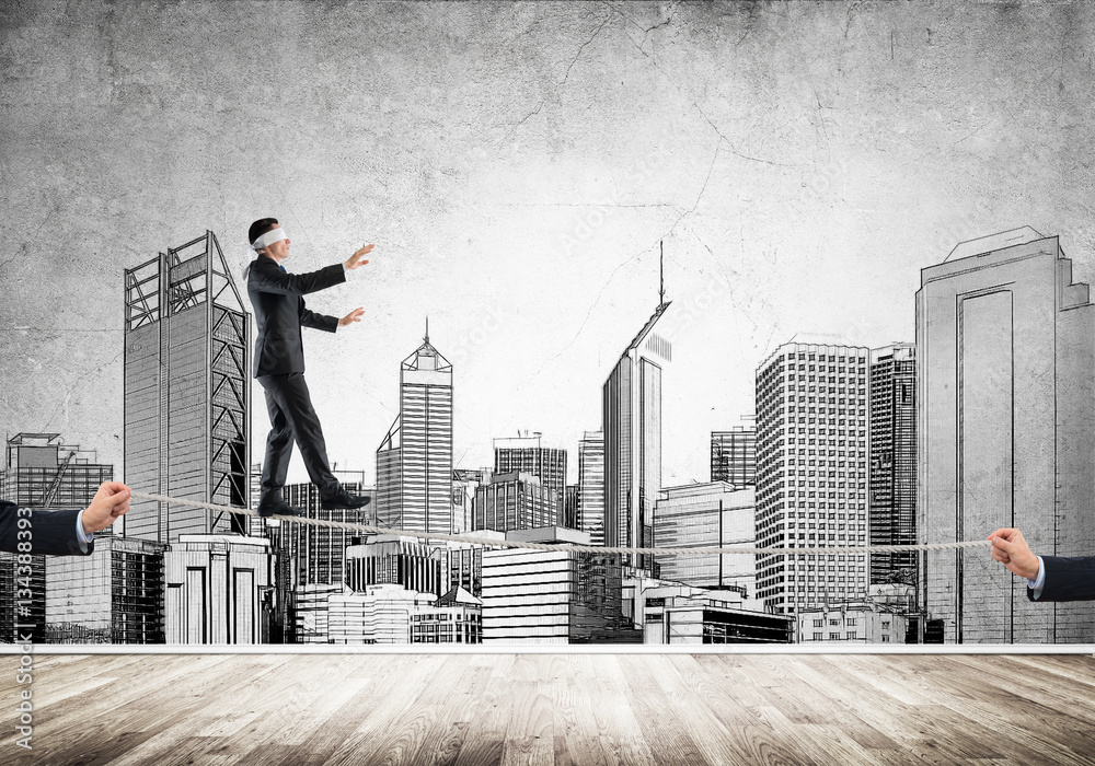 Business concept of risk support and assistance with man balancing on rope Business concept of risk support and assistance with man balancing on rope