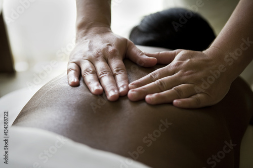 Woman receiving a back massage at spa