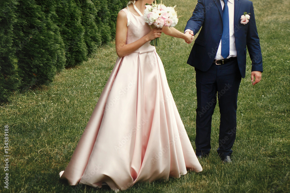 luxury bride holding groom hand and walking, gorgeous pink and w luxury bride holding groom hand and walking, gorgeous pink and w