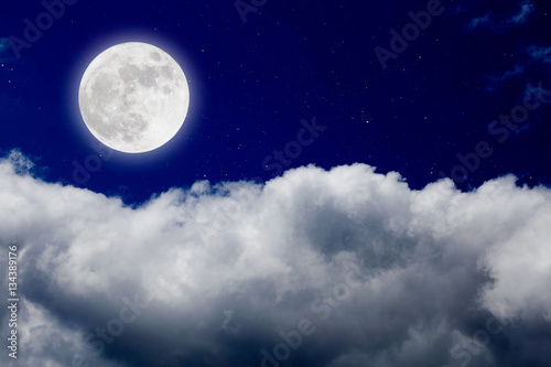 Romantic night with full moon in space over stars with cloudscap