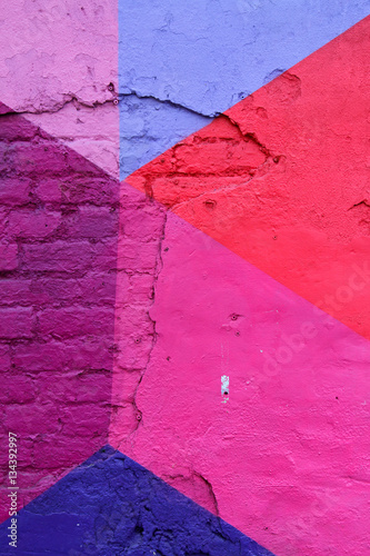Colorful (purple, blue and pink) brick wall as background, texture