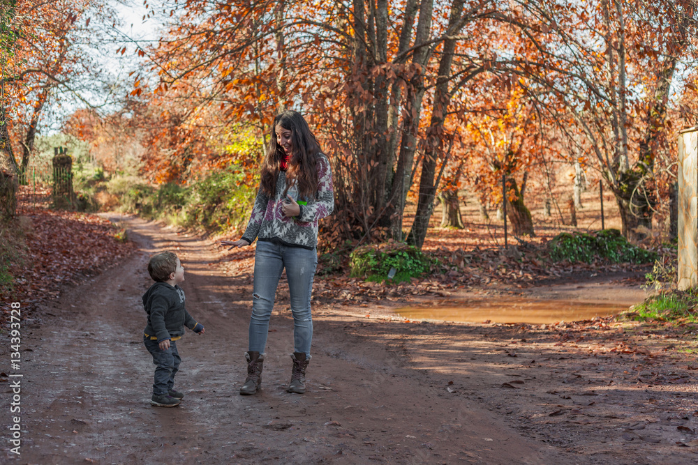 Portrait woman and smiling baby boy enjoying a nature walk. Autu Portrait woman and smiling baby boy enjoying a nature walk. Autu