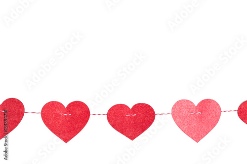 Small Red Hearts with Stitches Hanging on a String with Clothespin above wall on Light white Background