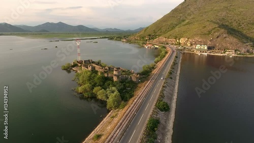 Fort Lesendro is on island in the middle of the Skadar lake. Dam with railway and highway. Aerial view. Vranjine, Montenegro
 photo