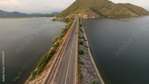 Flying over highway through the Lesendro fort on Skadarsko lake, near Podgorica. Ancient ruins of fortifications are on island (now peninsula). Skadar lake, Vranjine, Montenegro
 photo