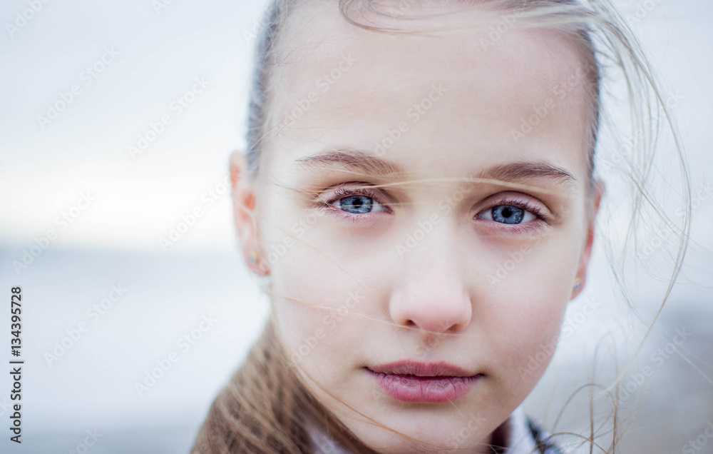 Close-up portrait of the beautiful little girl on cold background Close-up portrait of the beautiful little girl on cold background