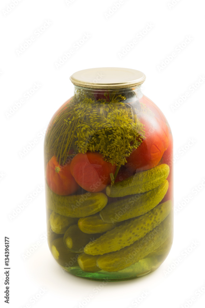 Pickled cucumber and tomato in glass jar isolated Pickled cucumber and tomato in glass jar isolated