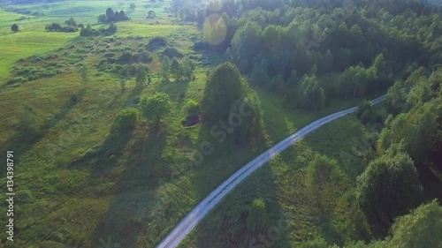 flying above green forest at summer time photo