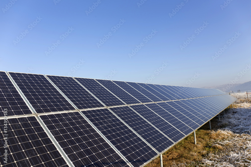 Solar Power Station in the snowy freeze winter Nature