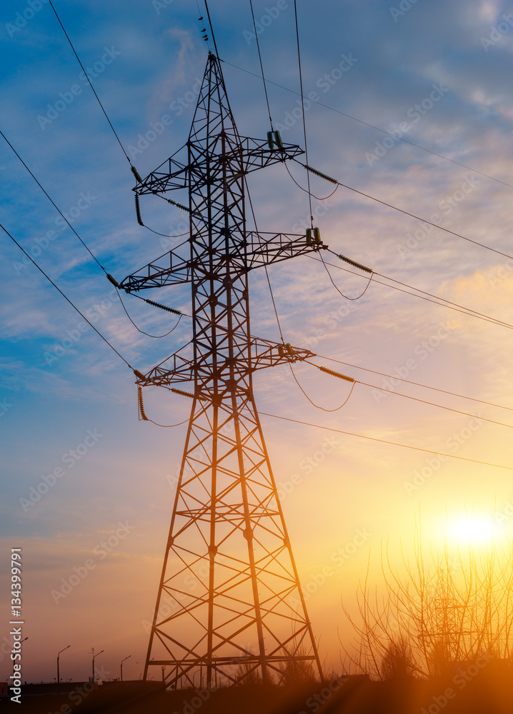 Electricity Pylon over orange sunset sky
