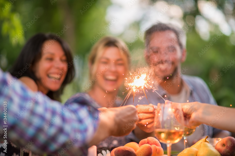 On a terrace friends enjoy themselves by lighting spark sticks On a terrace friends enjoy themselves by lighting spark sticks