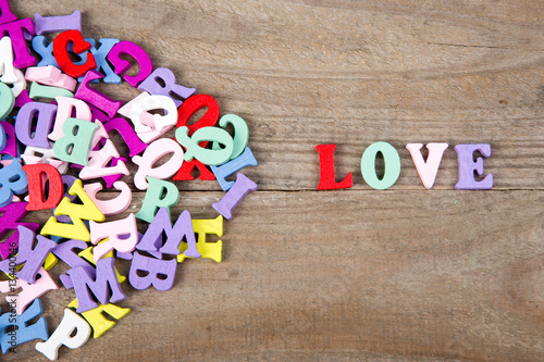 Bild auf Leinwand Text Love of colored wooden letters on a wooden background