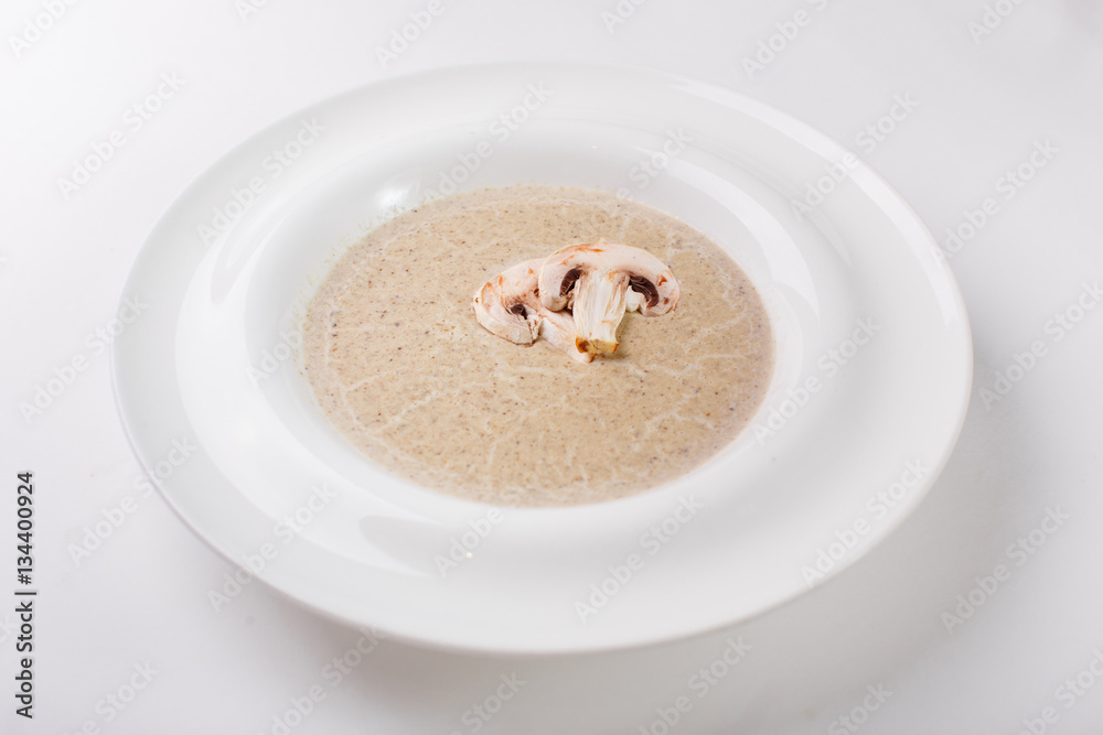 Cream soup with mushrooms on a white plate Cream soup with mushrooms on a white plate