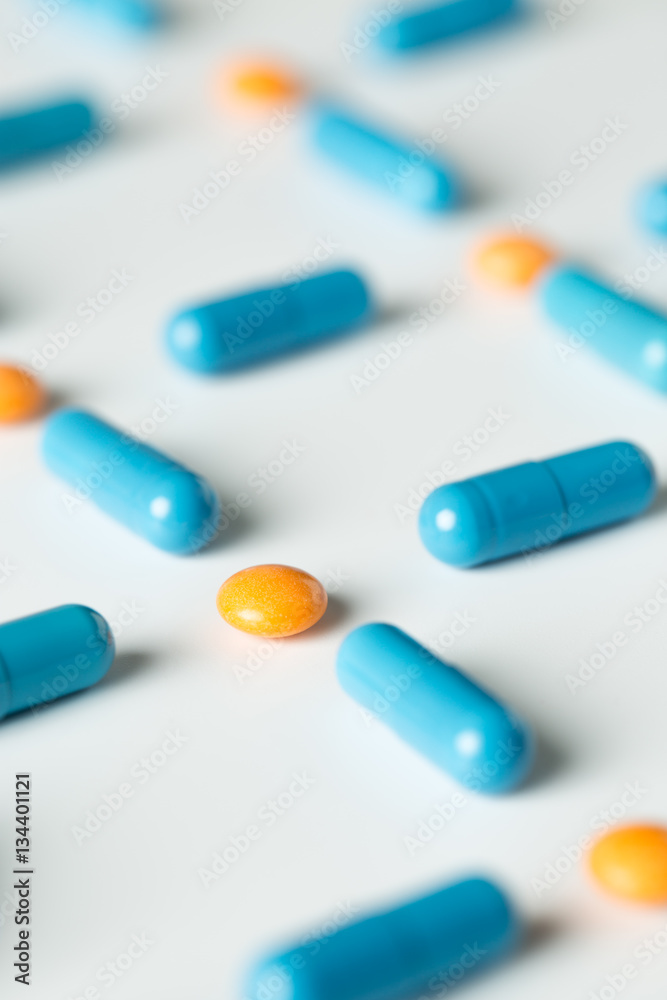 Blue medical pills and capsules pattern on white background. flat lay, top view. Blue medical pills and capsules pattern on white background. flat lay, top view.