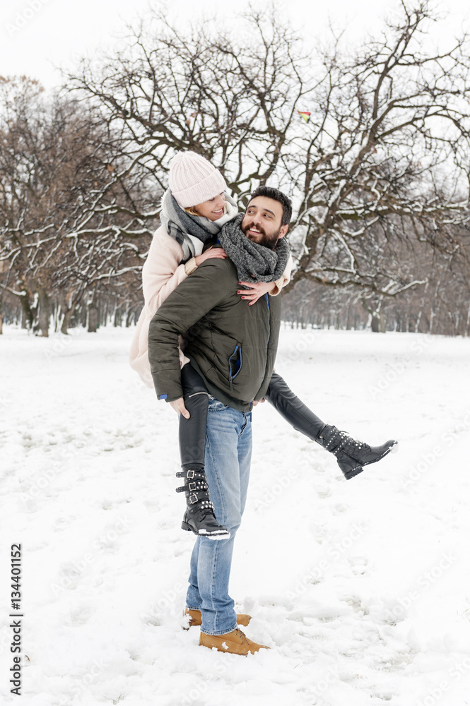 Loving couple enjoying the snow in the park