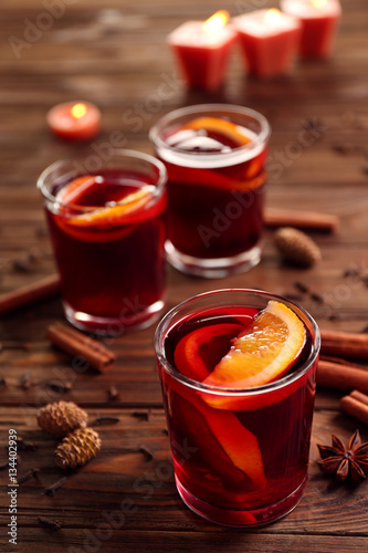 Glasses of delicious Christmas mulled wine on wooden background