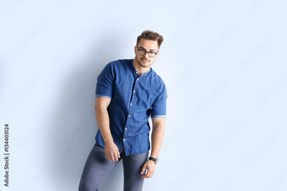 Fototapeta premium Handsome man on wall background