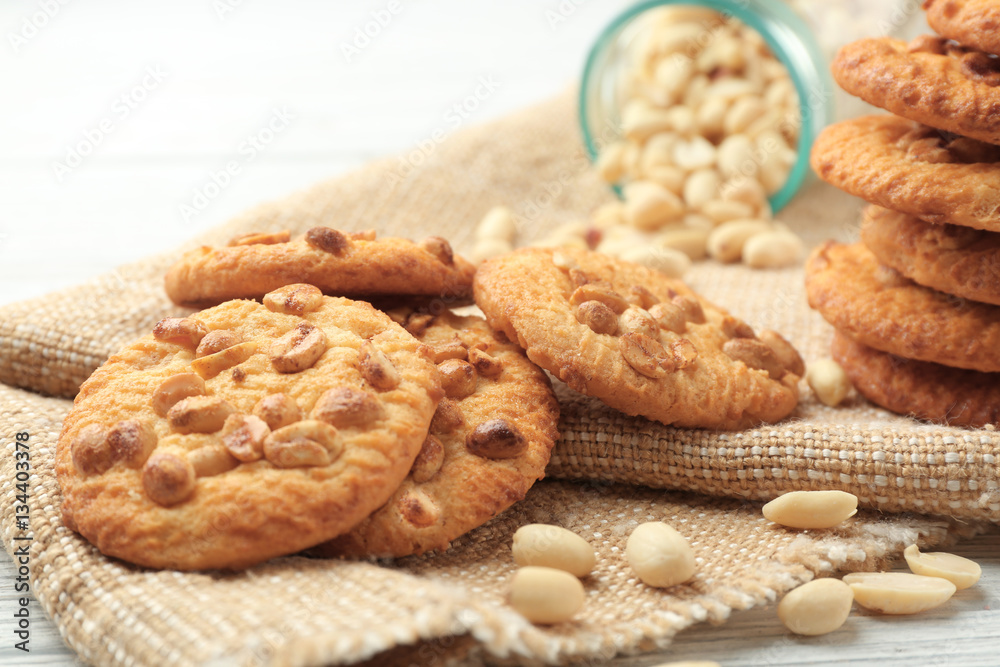 Composition with delicious peanut cookies, nuts on sackcloth Composition with delicious peanut cookies, nuts on sackcloth