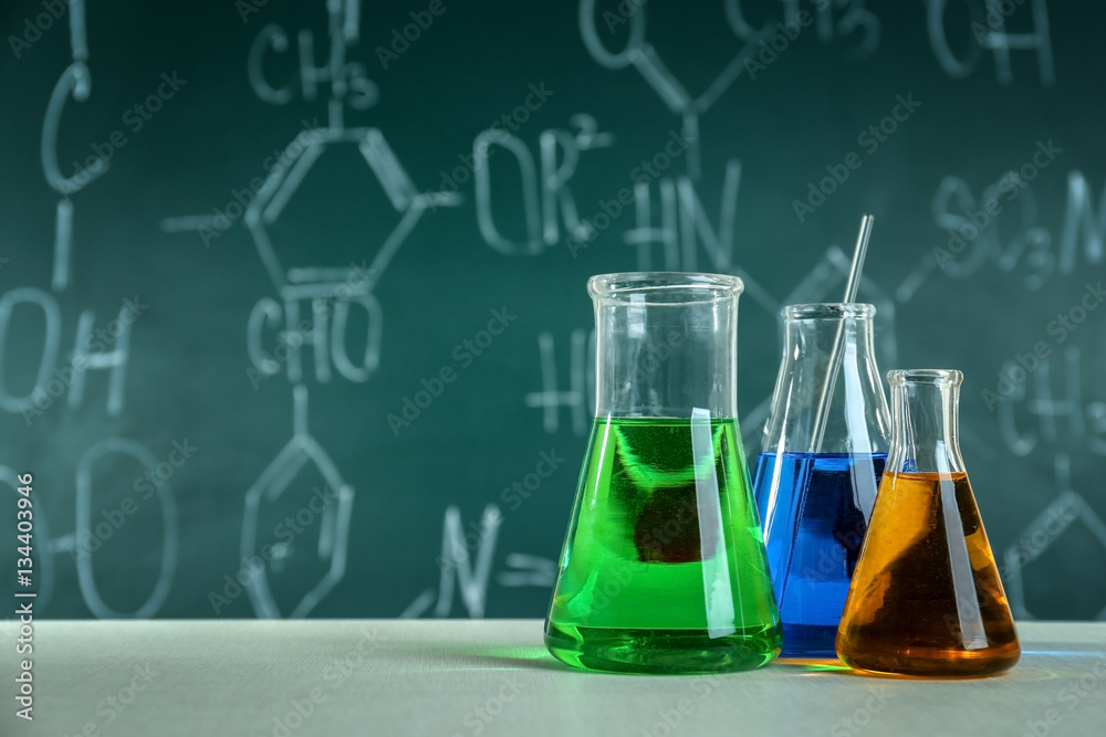 Test beakers and flasks on blackboard background Stock Photo | Adobe Stock
