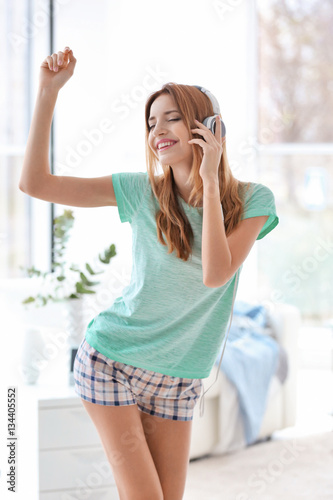 Beautiful young woman liste...