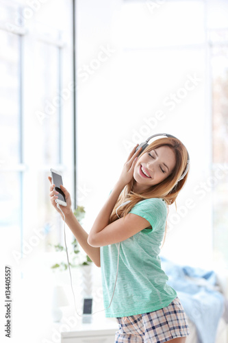 Beautiful young woman liste...