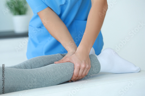 Physiotherapist working with patient in clinic, closeup